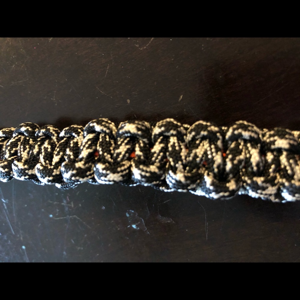 A black and white paracord rope keychain